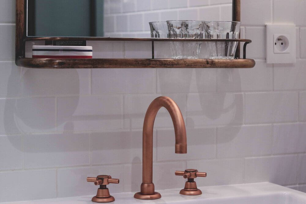 Hoxton Paris - Copper tap against white tiles 