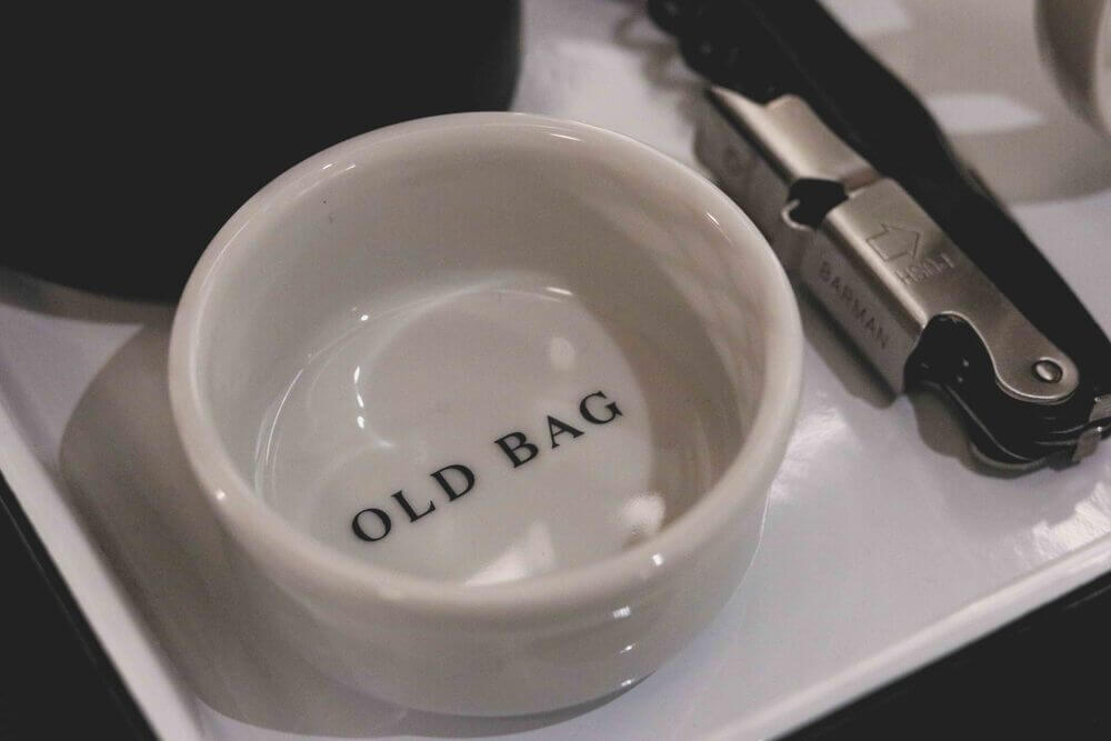 Hoxton Paris - white china tea bag holder with the words 'Old bag'