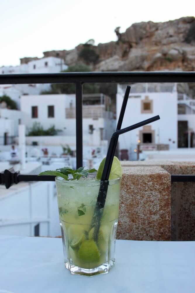 Lindos - mojito in front of white stone buildings