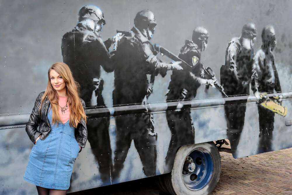 Eppie in front of a trailer with soldiers painted in black and white