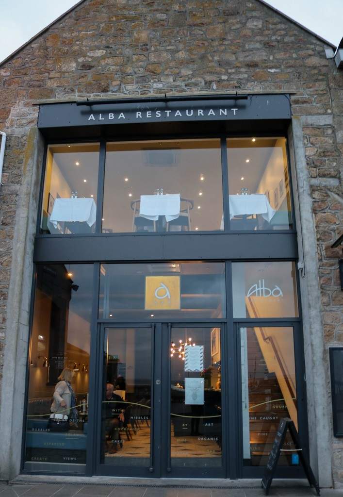 Alba Restaurant Review - Exterior of Alba. Stone building with modern black metal window