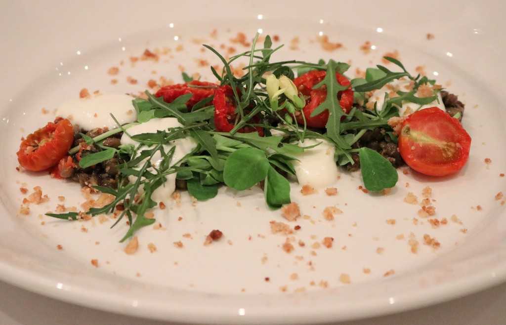 Alba Restaurant Review - A white oval plate with tomato and salad leaves